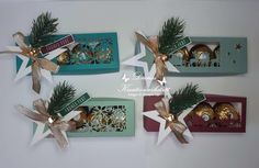 three boxes with christmas decorations on top of them