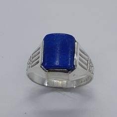 This elegant, Lapis Lazuli Ring has been carefully handcrafted in 925 Sterling Silver and authentic Lapis Lazuli.  This impressive ring is great for any occasion! buy it for someone special or buy it for your-self! Upon request a personalized message can be added to the inside of the ring.   Ring is size 10 (available in any size) Ring weights 3.8 grams Face of the ring is: 14.60 mm x 11.56 mm Ring Band is 2.90 mm Once ring has been shipped a tracking number will be provided to you. Know a littl Ceremonial White Gold Rings, Ceremonial Hallmarked Jewelry, Traditional Hallmarked Blue Rings, Traditional Blue Hallmarked Rings, Jewelry Men Ring, Ring Men Silver, Men Signet Ring, Men Silver Ring, Under Lock And Key