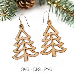 the wooden christmas tree earrings are shown with pine cones