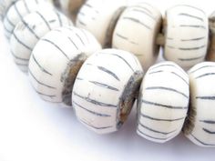 several white beads with black stripes on them