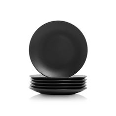 four black plates stacked on top of each other in front of a white background,