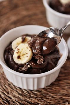 a bowl filled with chocolate pudding and banana slices