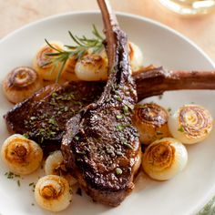 a white plate topped with meat and potatoes