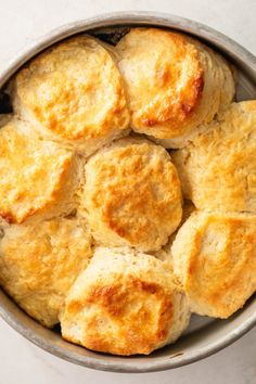 a bowl filled with biscuits sitting on top of a table