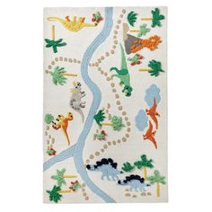 a white rug with dinosaurs and trees on it