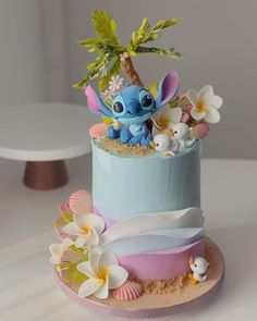 there is a cake decorated with an image of stitch and lillies on top of it