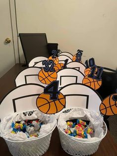 basketball themed birthday party decorations and centerpieces on a table with baskets filled with candy