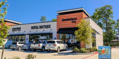 several cars are parked in front of a dental boutique