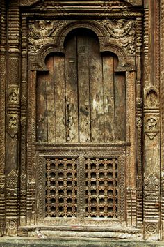 an old wooden door with intricate carvings on it