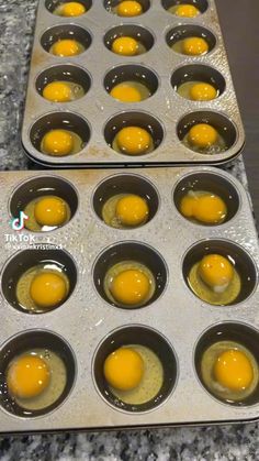 two trays filled with eggs sitting on top of a counter