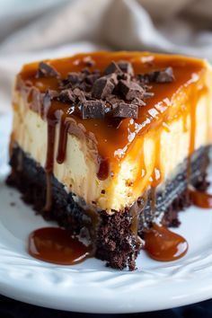 a piece of cheesecake with chocolate and caramel sauce