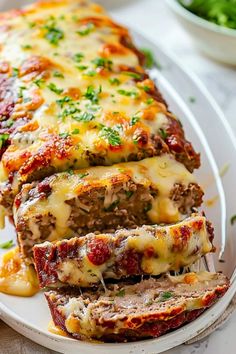 meatloaf stuffed with cheese and sauce on a white plate