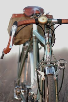 an old bicycle is parked in the grass