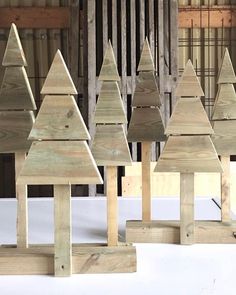 wooden christmas trees are lined up in rows