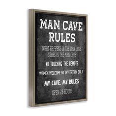 a sign that says man cave rules hanging on the wall in front of a white background