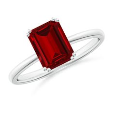 a ring with an emerald cut red stone