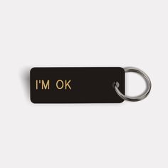 a black and gold keychain with the words new job on it