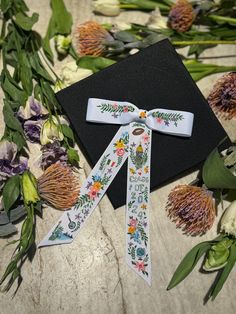 a black graduation cap with flowers on it