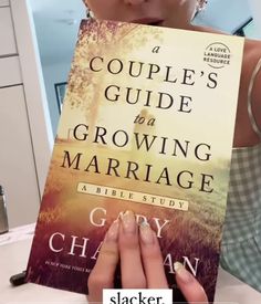 a woman holding up a book in front of her face with the title couple's guide to growing marriage