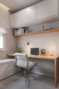 an office area with a desk, chair and bookshelf