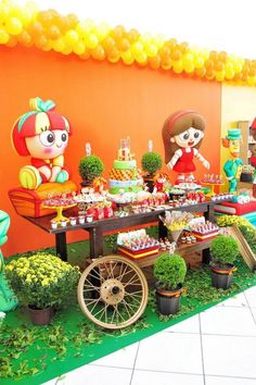 the table is set up for a children's birthday party with balloons and decorations