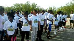 a group of people in white shirts standing together