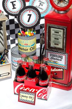 coca - cola bottles are sitting in front of an old fashioned clock and coke machine