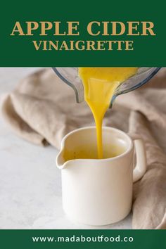 an apple cider vinaigrette being poured into a cup