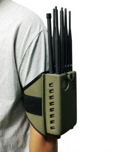 a man wearing an arm guard with several cell phones attached to it's back