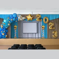 balloons and streamers decorate the stage for a new year's eve celebration