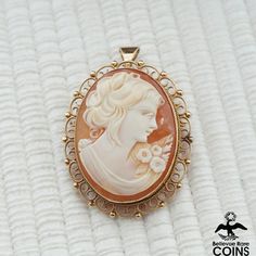 Metal: 14k Yellow Gold Weight: 10.9 grams Measurements: 1.6" x 1.2" (length x width) *Delicately hand-carved this beautiful cameo brooch/pendant features an image of a woman looking right, set in a 14k yellow gold bezel. This outstanding Victorian cameo is in beautiful condition, with light wear & patina. Don't let this exquisite brooch escape your grasp and add to your cart today! *Please See Photos! Elegant Carved Brooches For Gifts, Carved Oval Brooches For Formal Wear, Carved Oval Brooch For Formal Wear, Carved Oval Brooch For Formal Occasions, Ornate Oval Carved Brooches, Ornate Carved Oval Brooches, Carved Brooches For Formal Occasions, Elegant Carved Gold Brooches, Elegant Medallion Brooch For Collectors