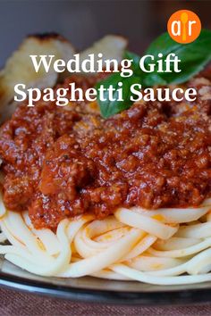 a plate of spaghetti sauce with bread on the side and text reading wedding gift spaghetti sauce