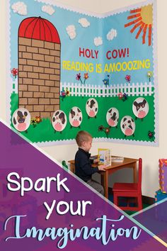 a young boy sitting at a table in front of a bulletin board that says spark your imagination