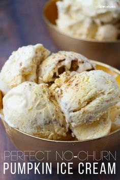 two bowls filled with pumpkin ice cream on top of a wooden table next to each other