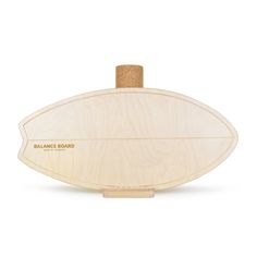 the balance board is made from wood and has a cork top on one end, and an oval shape on the other side