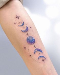 a woman's arm with three phases of the moon and stars on it