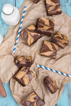 chocolate peanut butter brownies on parchment paper next to milk