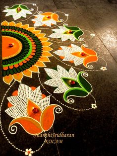 an artistic design on the ground for diwaling with flowers and leaves painted on it