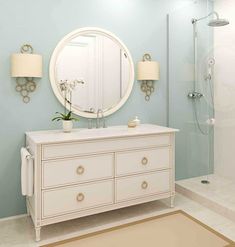 a bathroom with blue walls and white furniture