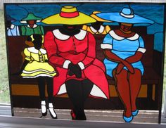 a stained glass window with two women sitting on a bench in front of the water