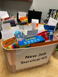 a new job survival kit in a basket on a counter top with notes and pens