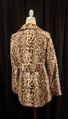 This wonderful vintage faux fur jacket is in great condition! This sweet little jacket is ready for that special someone. Another incredible vintage piece for your viewing! This coat was tag that reads - Made in U.S.A. Self: 60% Rayon 40% Cotton Lining: 100% Acetate With exclusive trim DRY CLEAN ONLY Coat measures ~ Shoulders 16ish inches, Raglan Sleeve 25ish, Chest 38 inches and length is 28 inches. Buyer to pay all related shipping costs plus insurance. Questions are welcome. All sales final. Fitted Faux Fur Outerwear In Leopard Print, Fitted Leopard Print Faux Fur Outerwear, Retro Faux Fur Outerwear For Fall, Fitted Leopard Print Winter Outerwear, Vintage Leopard Print Winter Outerwear, Vintage Leopard Print Outerwear For Winter, Fitted Leopard Print Fur Coat For Fall, Fitted Retro Fur Coat For Fall, Retro Mink Outerwear For Fall