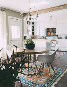 a dining room table with chairs and a potted plant on top of the table