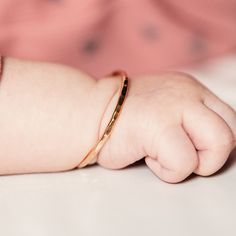 "Looking for a unique baby shower gift? Give your little ball of sunshine the cutest jewelry for every day. This will match her every outfit! M A T E R I A L Sterling Silver 14k Yellow Gold Filled 14k Rose Gold Filled S I Z E S Right out the womb 4 in Newborn hand circumference: 4 1/2 in Crawler hand circumference: 5 in Walker hand circumference: 5 1/2 in D E T A I L S Made of 12 gauge wire Packaged with a mesh pouch, perfect for gift giving. H O W ⋯ T O ⋯ S I Z E Step 1: Close your hand so that Cutest Jewelry, Unique Baby Girl Gifts, Mesh Pouch, Hammered Bracelet, Girl Bracelet, Baby Bangles, Unique Baby Shower Gifts, Infant Girl, Unique Baby Shower