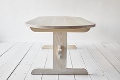 a wooden table sitting on top of a white floor