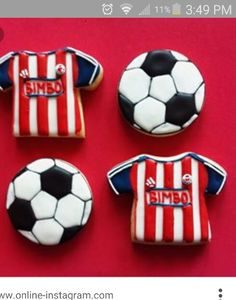 four cookies decorated like soccer jerseys and balls