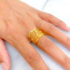 This 21k gold ring, weighing 2.3 grams, features a textured blooming design that exudes elegance and natural beauty. The yellow gold finish enhances its luxurious and radiant appearance. Sized at 8.25, this ring offers the option for resizing to ensure a perfect fit. Perfect for those who appreciate refined craftsmanship and floral motifs, this stunning ring is a standout addition to any jewelry collection. Product Details Gold Purity(karat): 21k Gold Weight(grams): 2.3 Item Finish: Yellow Gold Gold Plated Yellow Gold Filigree Ring For Anniversary, Elegant 22k Gold Toe Ring, 22k Yellow Gold Filigree Ring For Anniversary, 22k Gold Open Ring, Indian Rings, Bridal Jewelry Necklace, Precious Stones Rings, Diamond Pendant Sets, Modern Bracelets