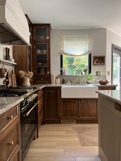 a kitchen with wooden cabinets and marble counter tops