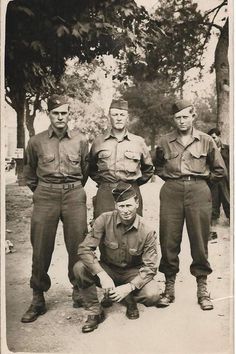 an old black and white photo of men in uniforms