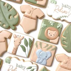 baby shower cookies are arranged in the shape of elephants, giraffes and leaves